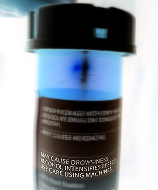Medications bottle with warning label about drug interactions with alcohol.