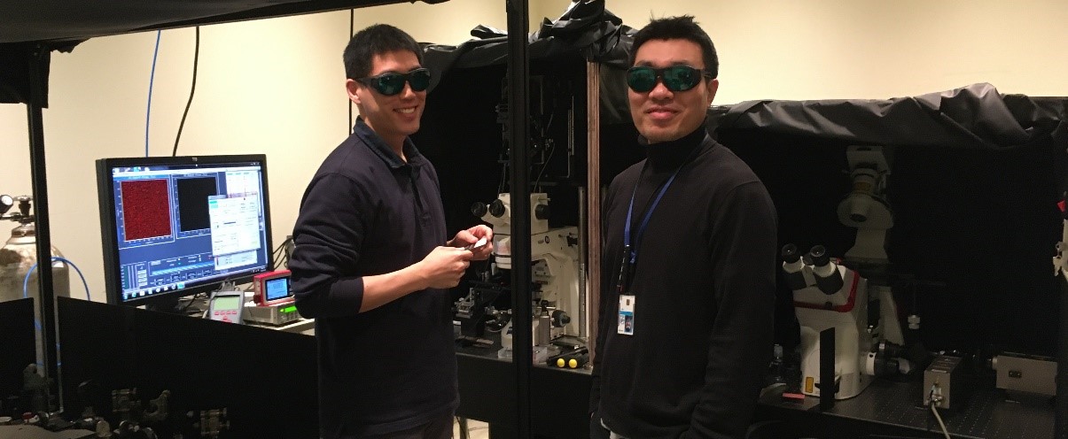 Drs. Youngchan Kim (left) and Jeong Lee (right) wearing protective goggles while aligning a LBQB laser FLIM-FRET microscope
