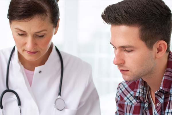 a woman doctor discuss with a man patient