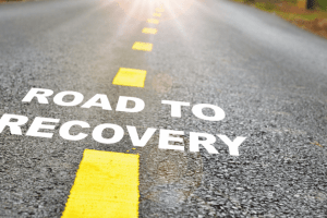 Road with text superimposed, "ROAD TO RECOVERY"